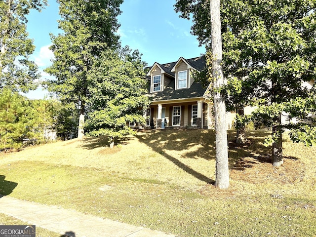 cape cod-style house with a front lawn