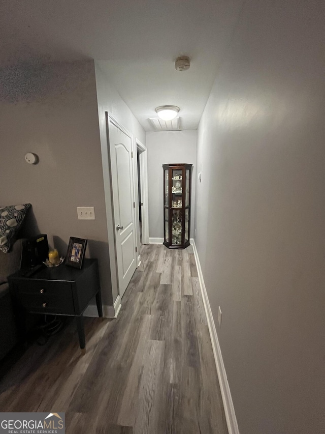 corridor featuring wood-type flooring