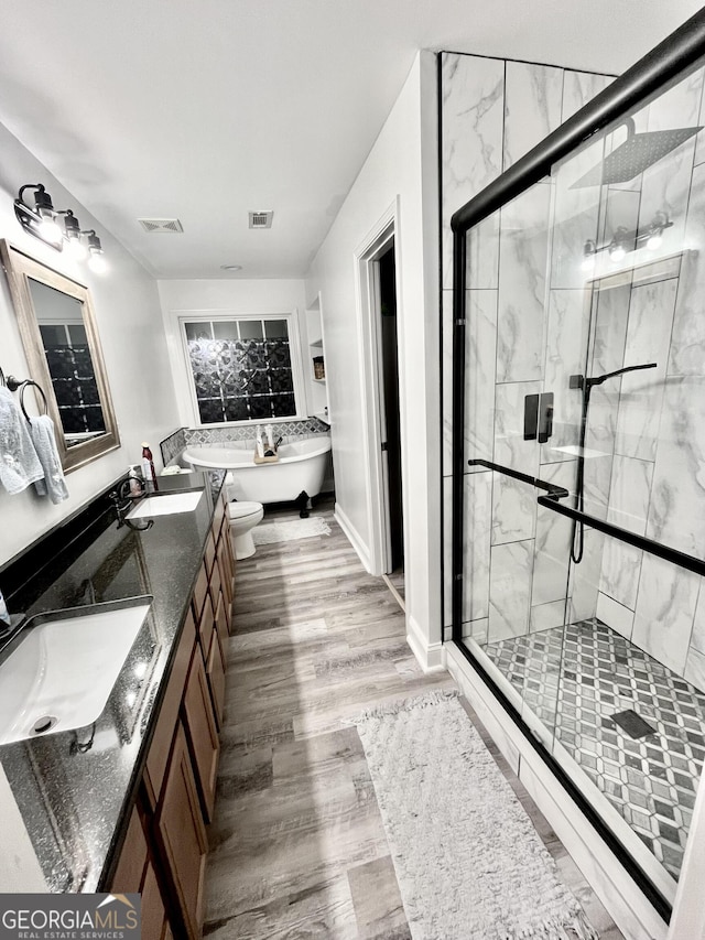 bathroom featuring vanity, plus walk in shower, and hardwood / wood-style floors