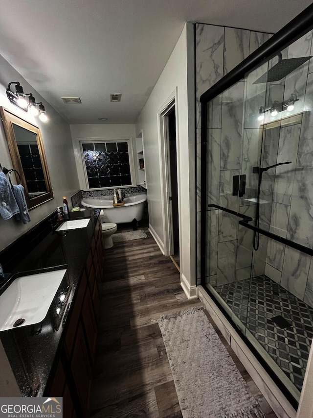 bathroom with separate shower and tub, hardwood / wood-style flooring, and vanity