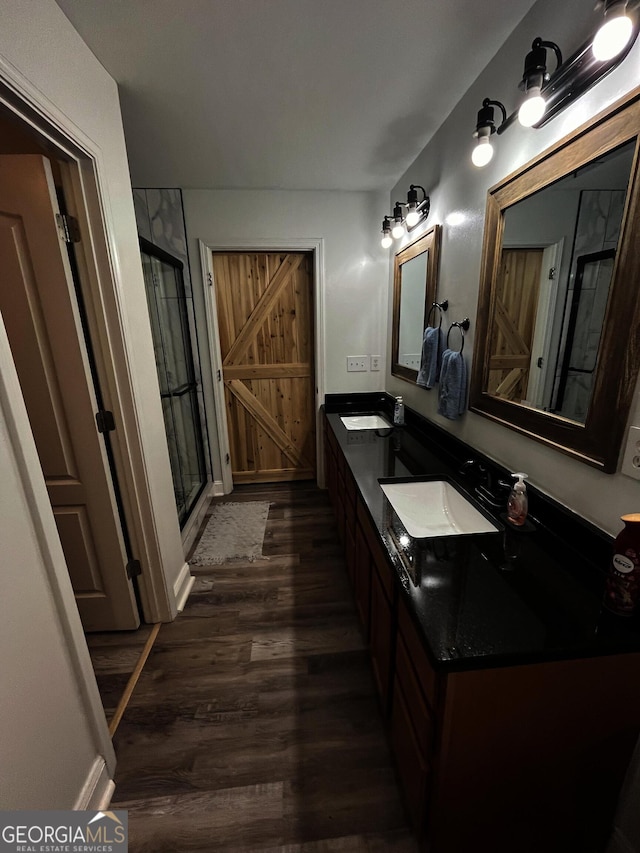 bathroom with vanity, hardwood / wood-style floors, and an enclosed shower