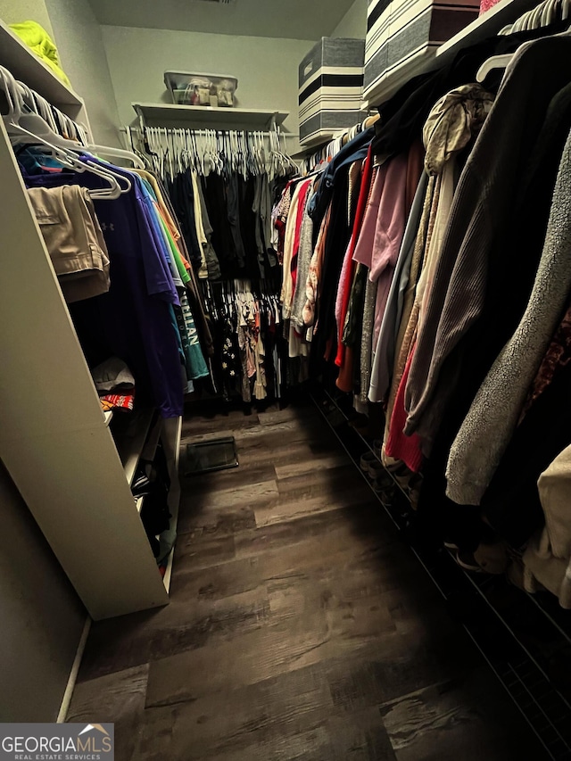 spacious closet featuring dark hardwood / wood-style floors