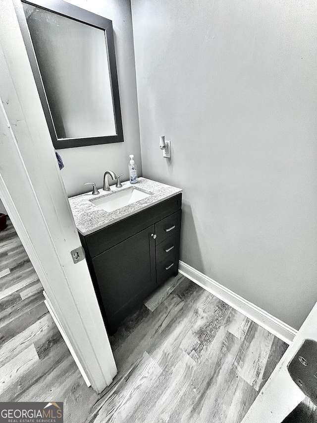 bathroom featuring vanity and hardwood / wood-style floors