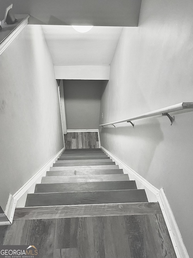 staircase featuring hardwood / wood-style flooring