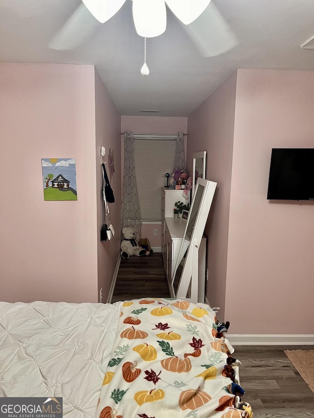 bedroom featuring ceiling fan and hardwood / wood-style floors