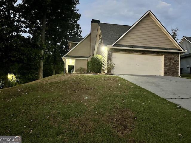 view of front facade featuring a garage and a front lawn