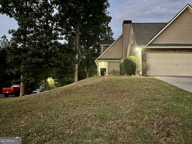 view of property exterior featuring a garage and a lawn