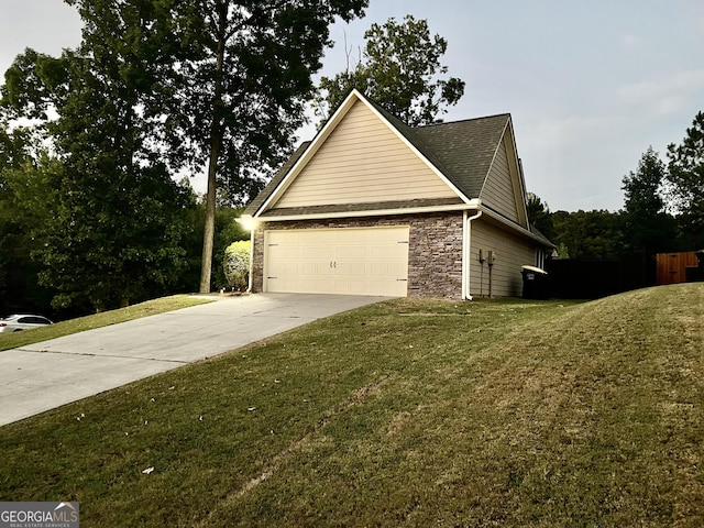 view of home's exterior with a lawn and a garage