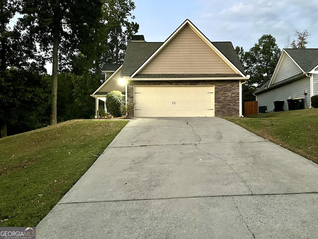 view of front of property featuring a front lawn and a garage