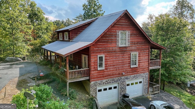 view of side of home with a balcony and a garage