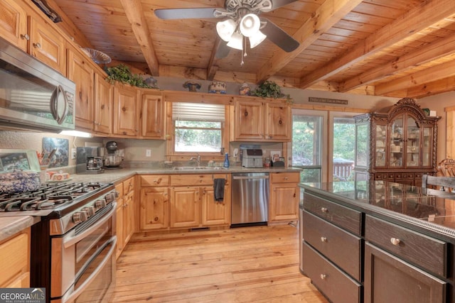 kitchen with appliances with stainless steel finishes, beamed ceiling, ceiling fan, light hardwood / wood-style flooring, and sink