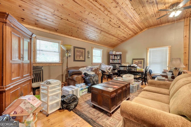 living room featuring ceiling fan, light hardwood / wood-style flooring, vaulted ceiling, and a healthy amount of sunlight