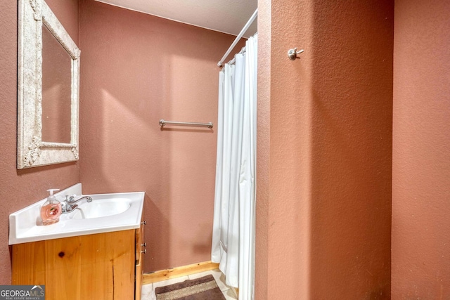 bathroom with vanity and a shower with shower curtain