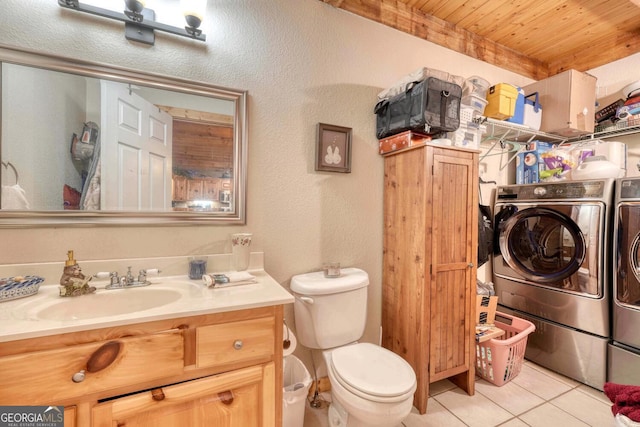 bathroom featuring vanity, toilet, washer and clothes dryer, wooden ceiling, and tile patterned flooring