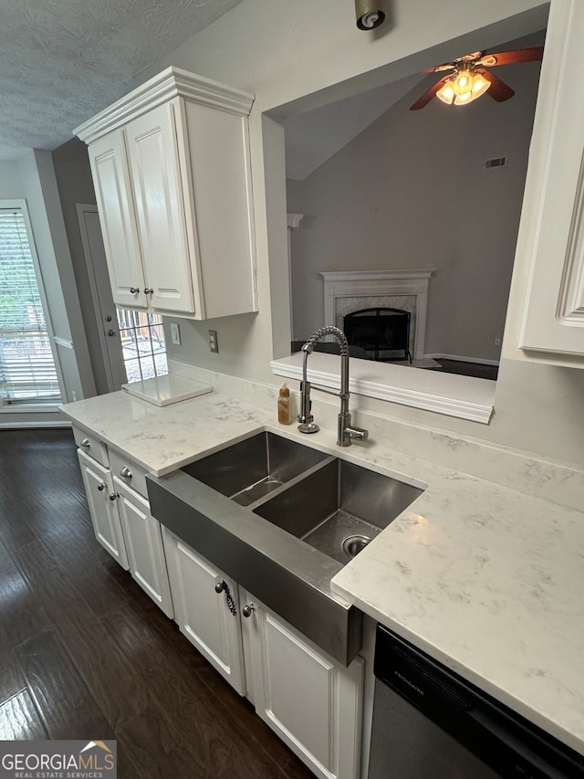 kitchen featuring sink, white cabinets, dark hardwood / wood-style flooring, ceiling fan, and stainless steel dishwasher