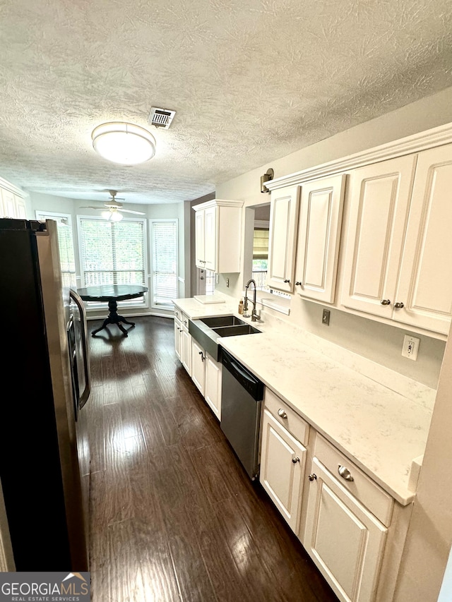 kitchen featuring dark hardwood / wood-style floors, sink, appliances with stainless steel finishes, light stone countertops, and ceiling fan