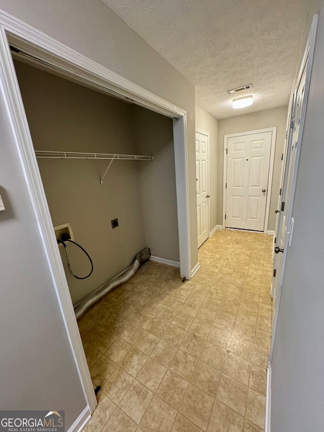 washroom featuring hookup for a washing machine, a textured ceiling, and hookup for an electric dryer