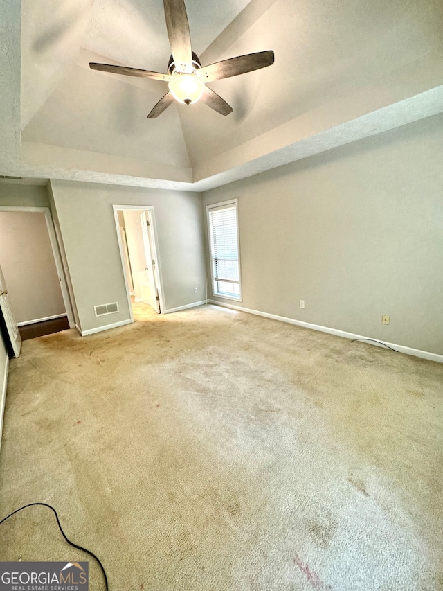 unfurnished bedroom with carpet, vaulted ceiling, and ceiling fan