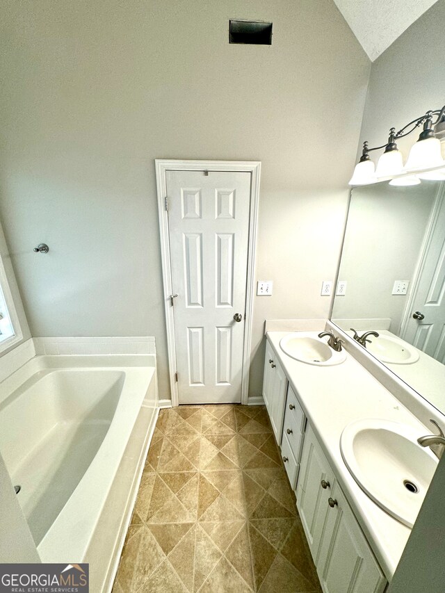 bathroom featuring a tub to relax in and vanity