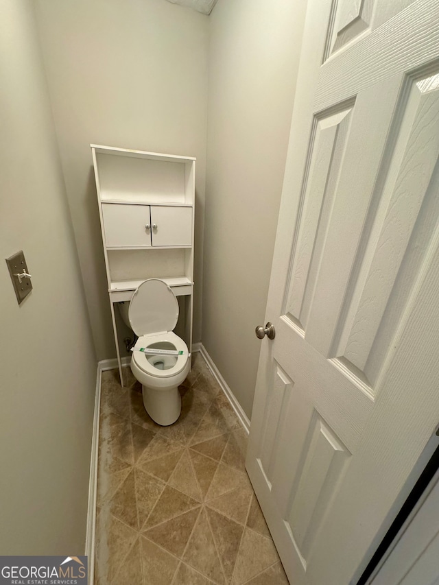 bathroom featuring toilet and tile patterned floors