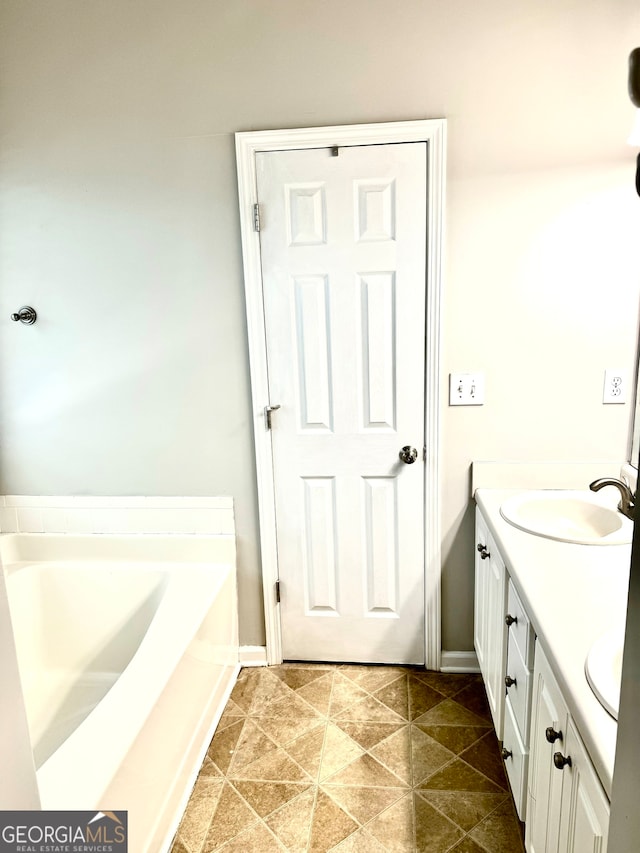 bathroom with vanity and a washtub