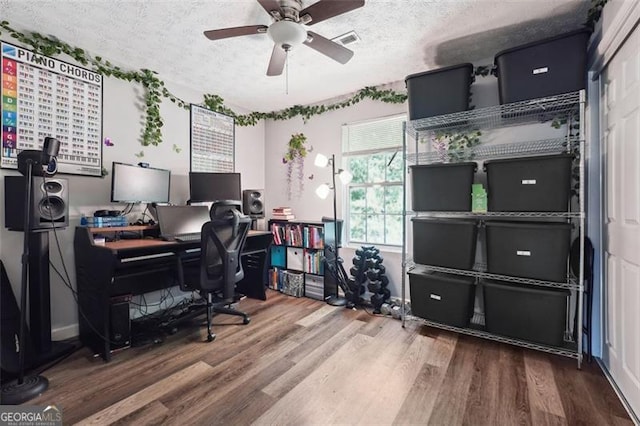 home office featuring ceiling fan, a textured ceiling, and hardwood / wood-style floors