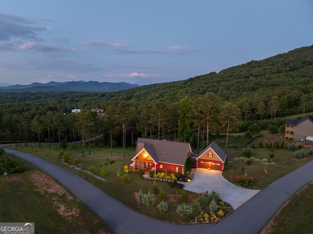 aerial view at dusk featuring a mountain view