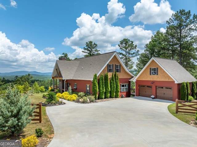 view of front facade with a mountain view, a garage, and a porch