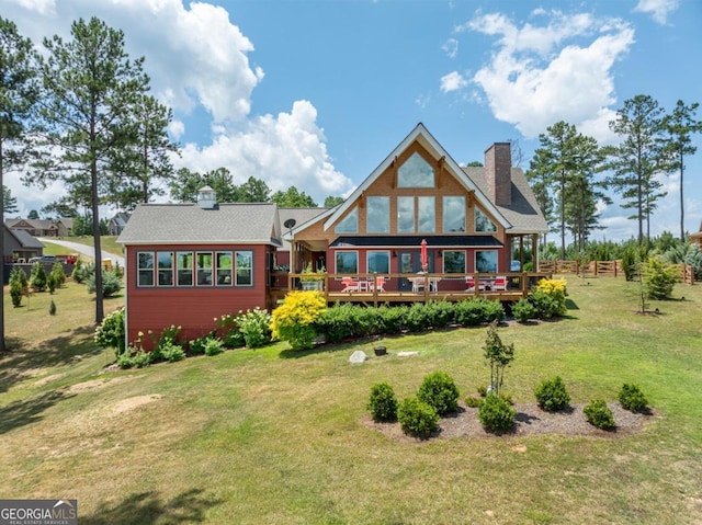 back of house with a yard and a wooden deck