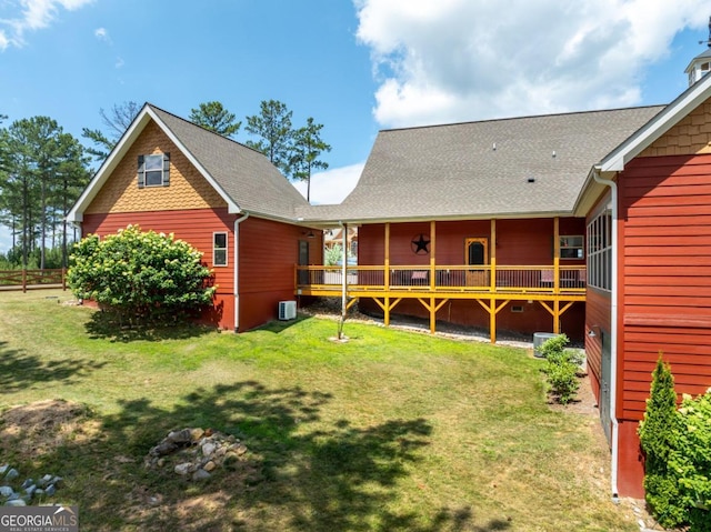 back of property featuring a lawn