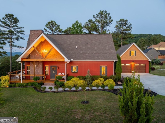 view of front of property with a garage and a front lawn