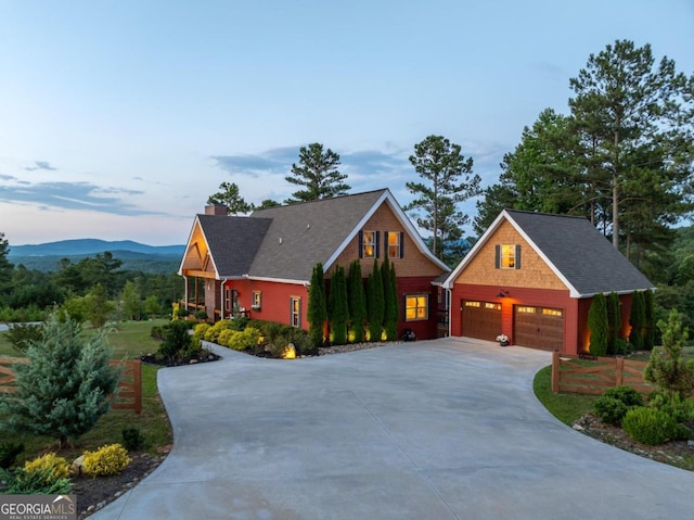 view of front of home with a mountain view and a garage