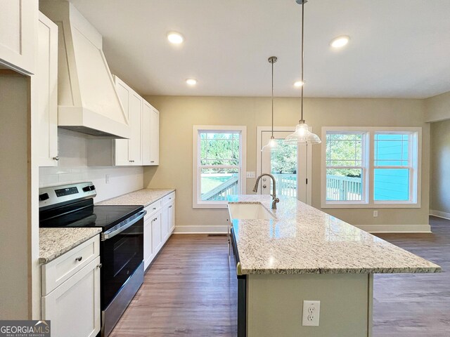 kitchen featuring dishwasher, dark hardwood / wood-style floors, a brick fireplace, decorative light fixtures, and light stone counters