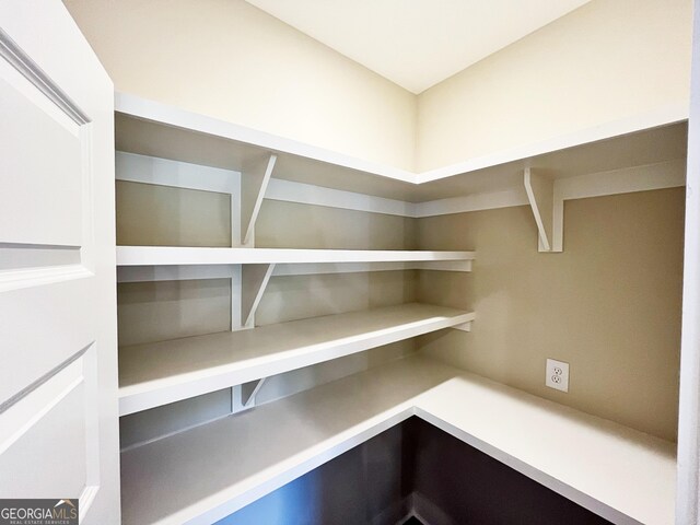 kitchen with a fireplace, stainless steel dishwasher, plenty of natural light, and pendant lighting