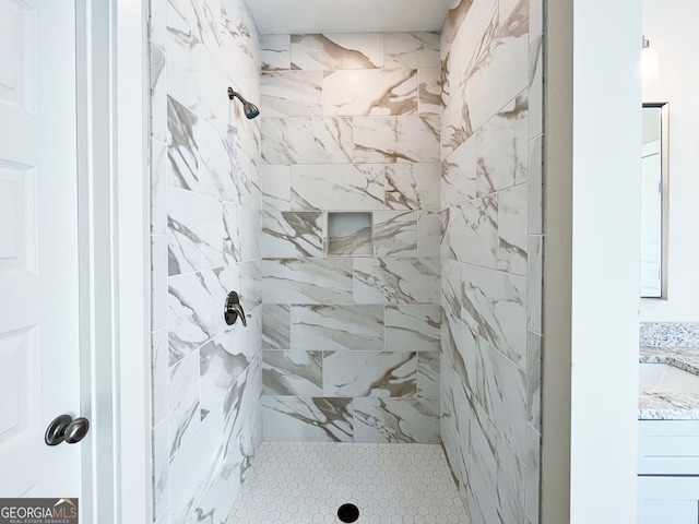 bathroom featuring vanity and tiled shower