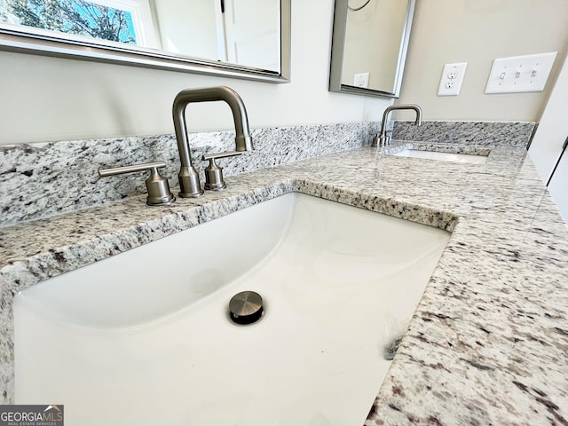 interior details featuring a sink and double vanity