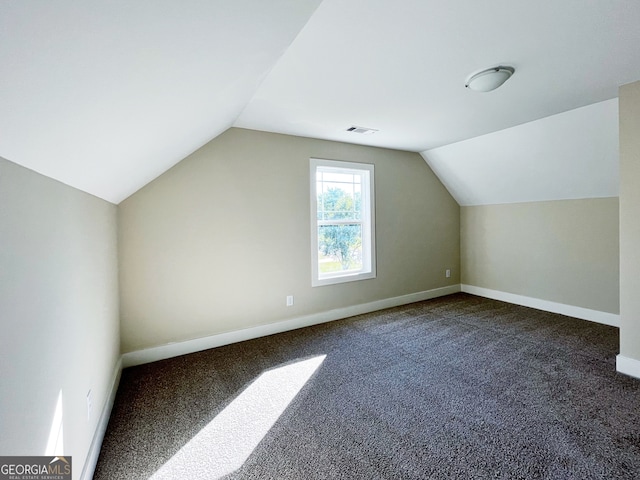 additional living space with vaulted ceiling and carpet floors