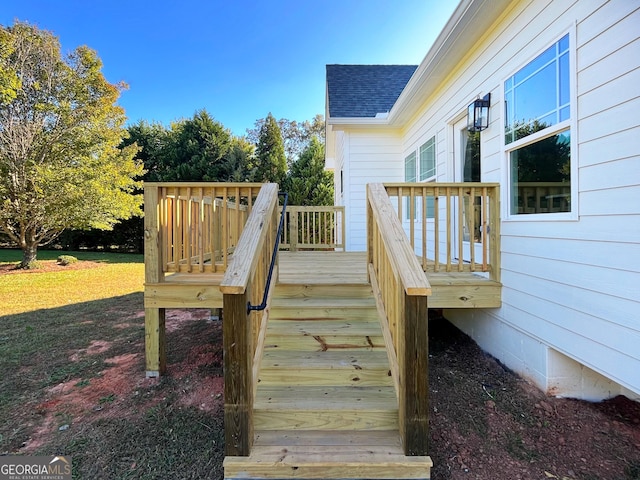 wooden deck featuring stairway and a lawn