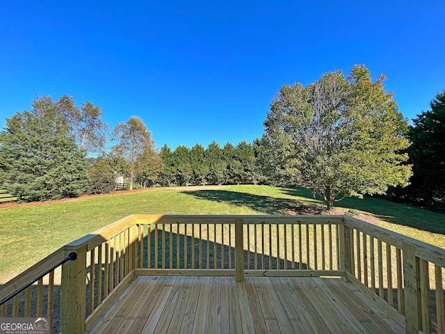 wooden terrace featuring a lawn