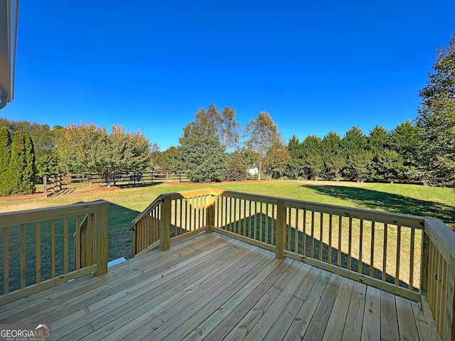 deck featuring fence and a yard