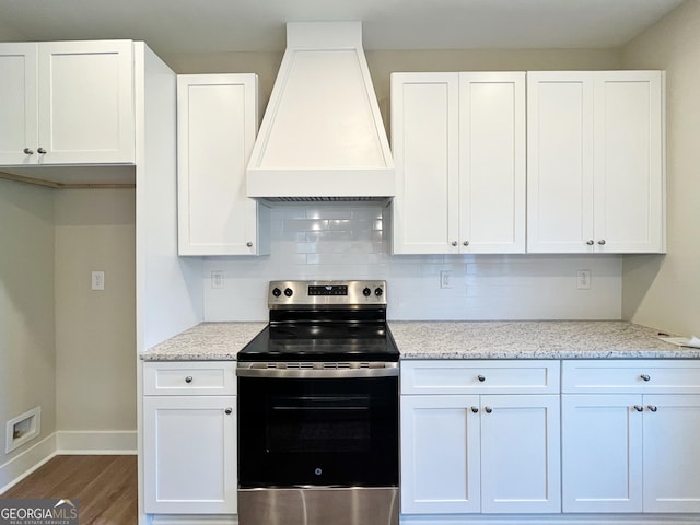 kitchen featuring premium range hood, wood finished floors, white cabinetry, stainless steel electric range, and decorative backsplash