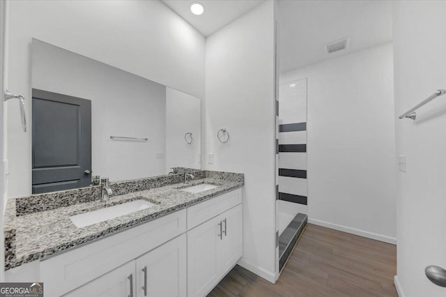 bathroom with vanity, a shower, and wood-type flooring