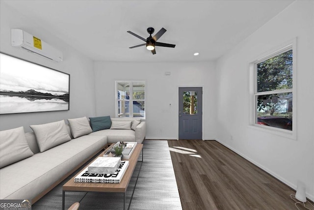 living room featuring ceiling fan, dark hardwood / wood-style flooring, and a wall unit AC