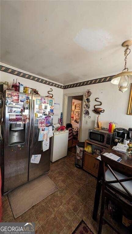kitchen with stainless steel appliances and washer / dryer