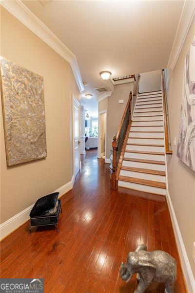 interior space with dark hardwood / wood-style floors and ornamental molding