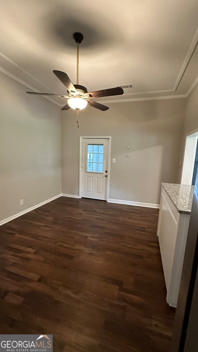 unfurnished room featuring crown molding, dark hardwood / wood-style floors, and ceiling fan