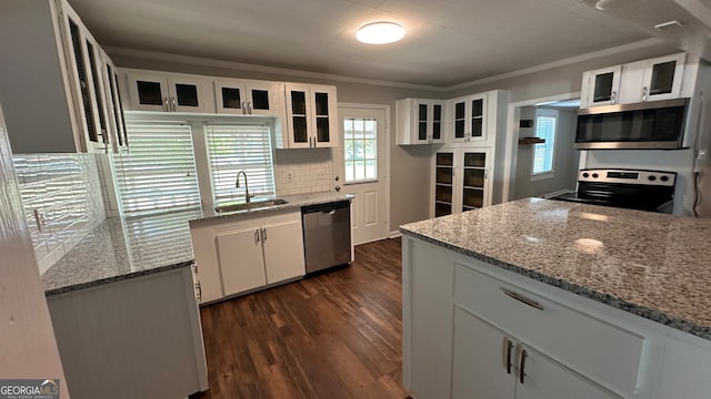 kitchen featuring light stone counters, sink, white cabinets, stainless steel appliances, and crown molding