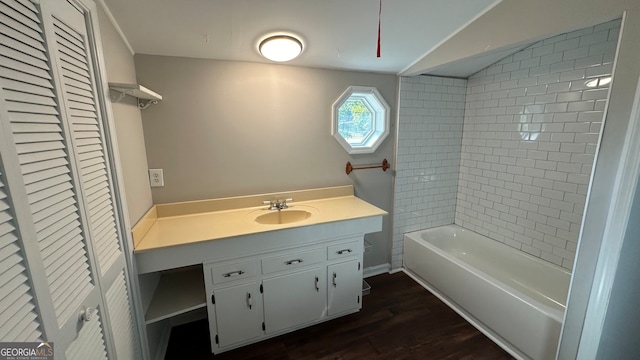 bathroom featuring tiled shower / bath, vanity, and hardwood / wood-style floors