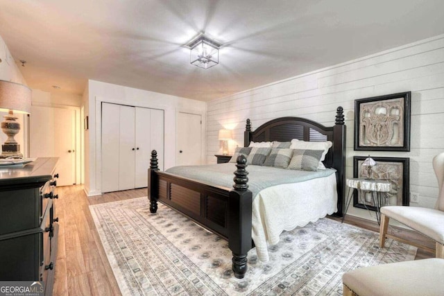 bedroom featuring light wood-style flooring and two closets