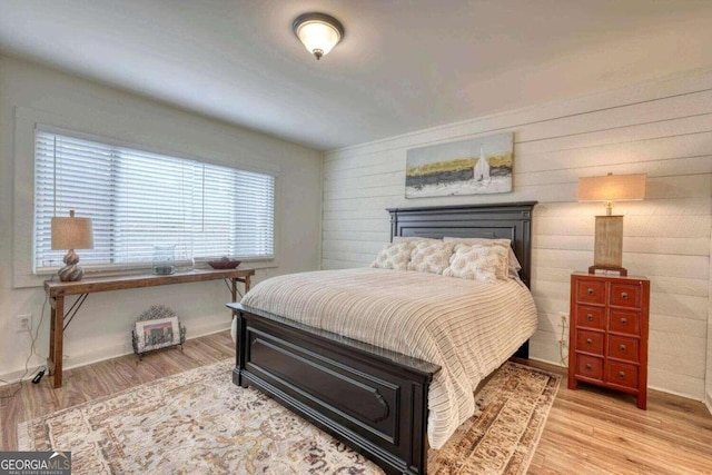 bedroom featuring light wood-style floors and baseboards